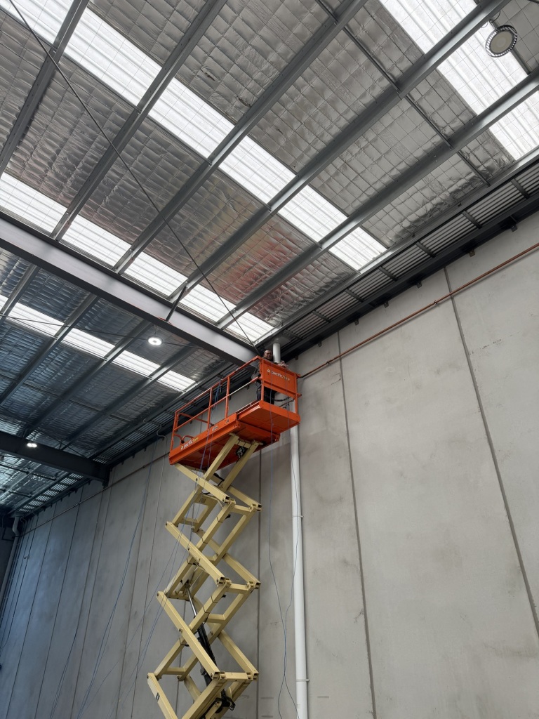 Cat6 cable installation along warehouse wall
