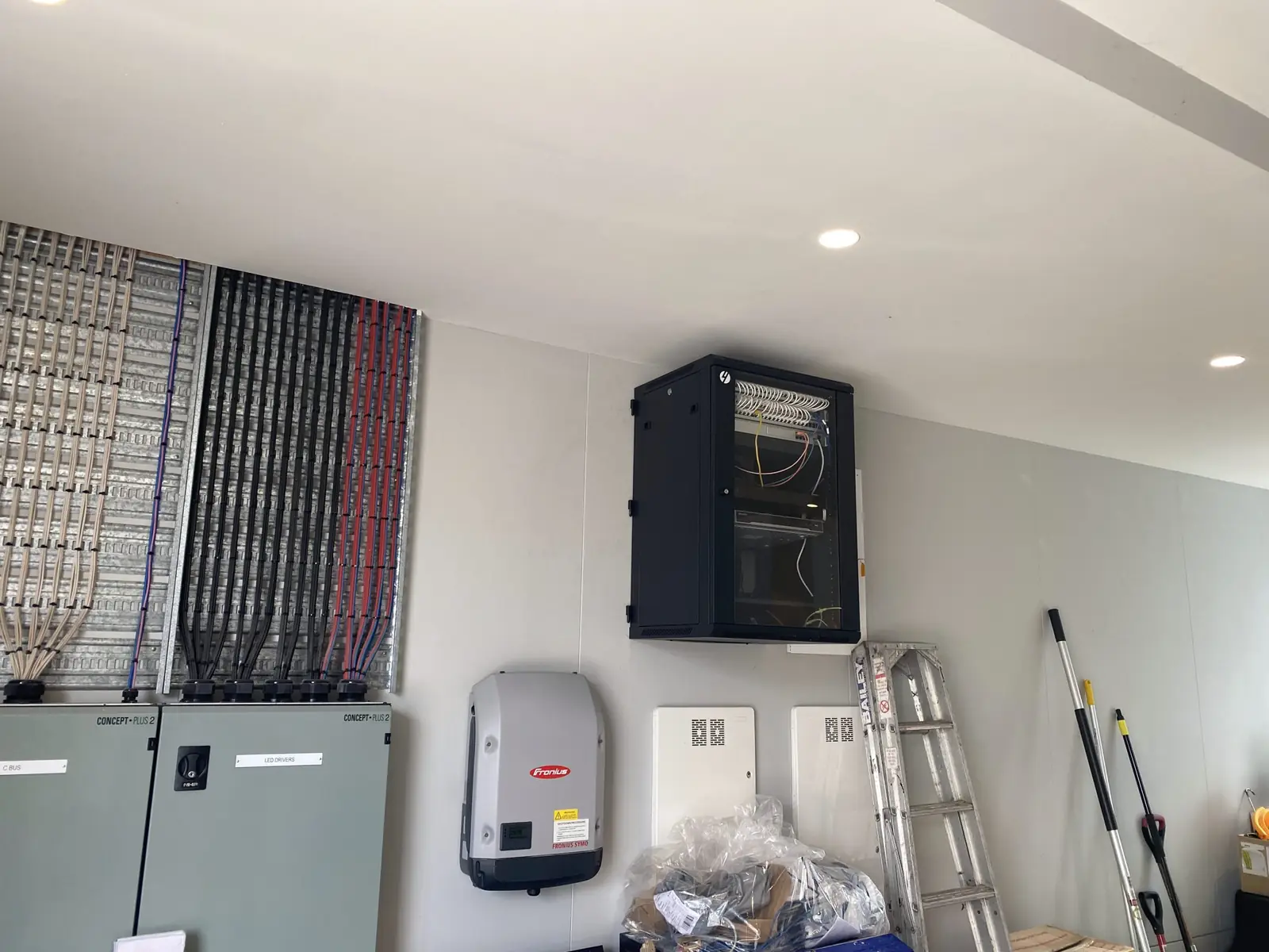 Industrial plant room with cable tray, coloured cabling and an electrical cabinet