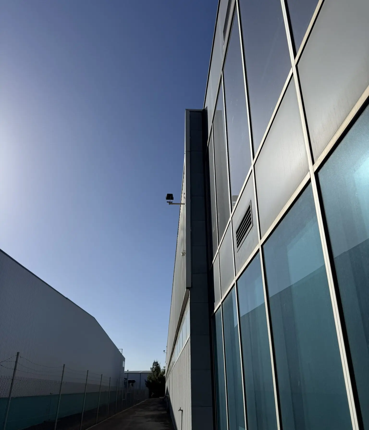 Modern commercial office building with metal cladding and full-height glazing